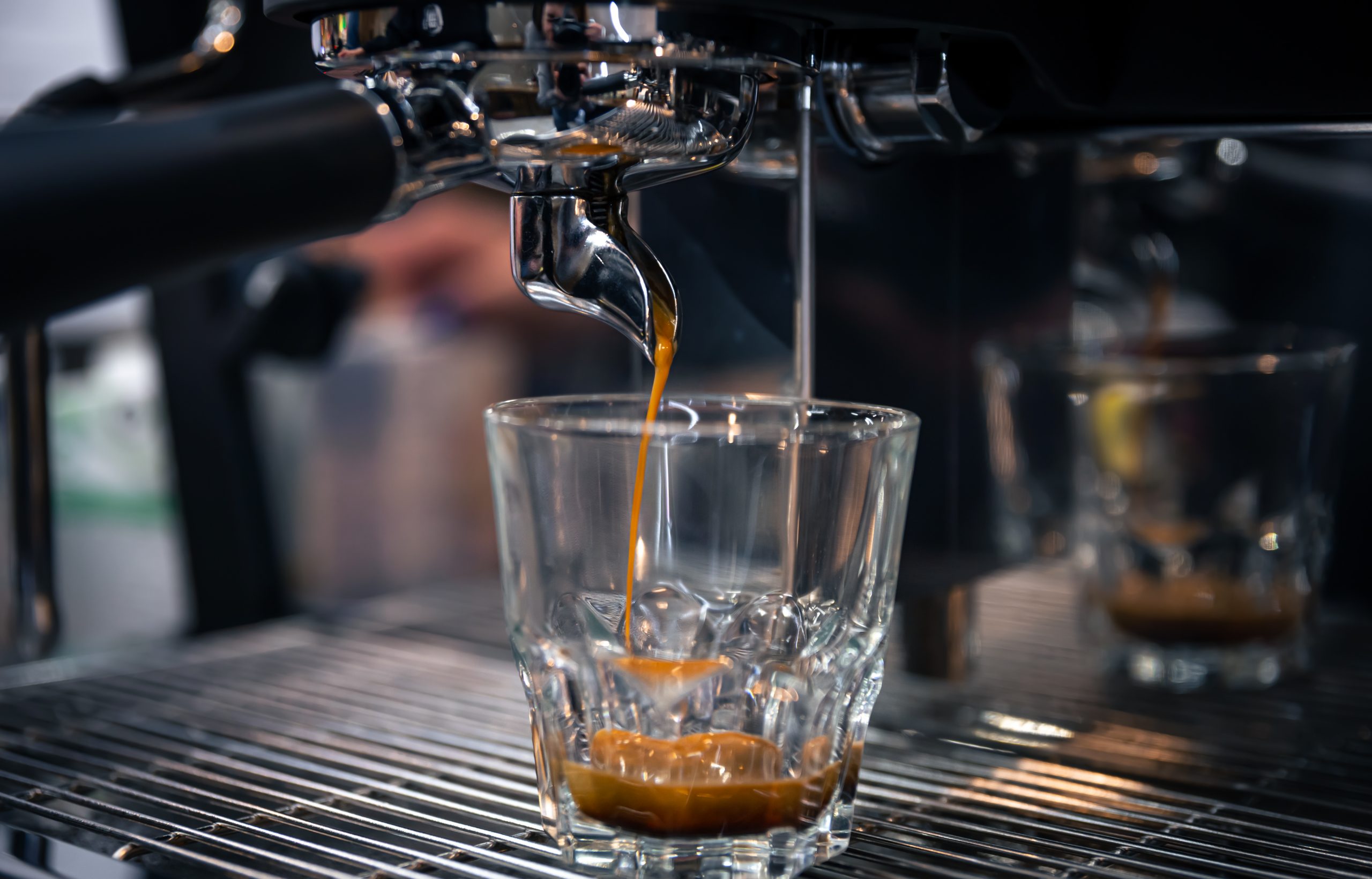 The process of preparing espresso in a professional coffee machine, close-up.